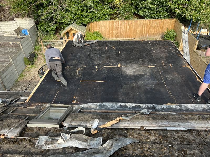 The crew stripping and preparing the flat roof