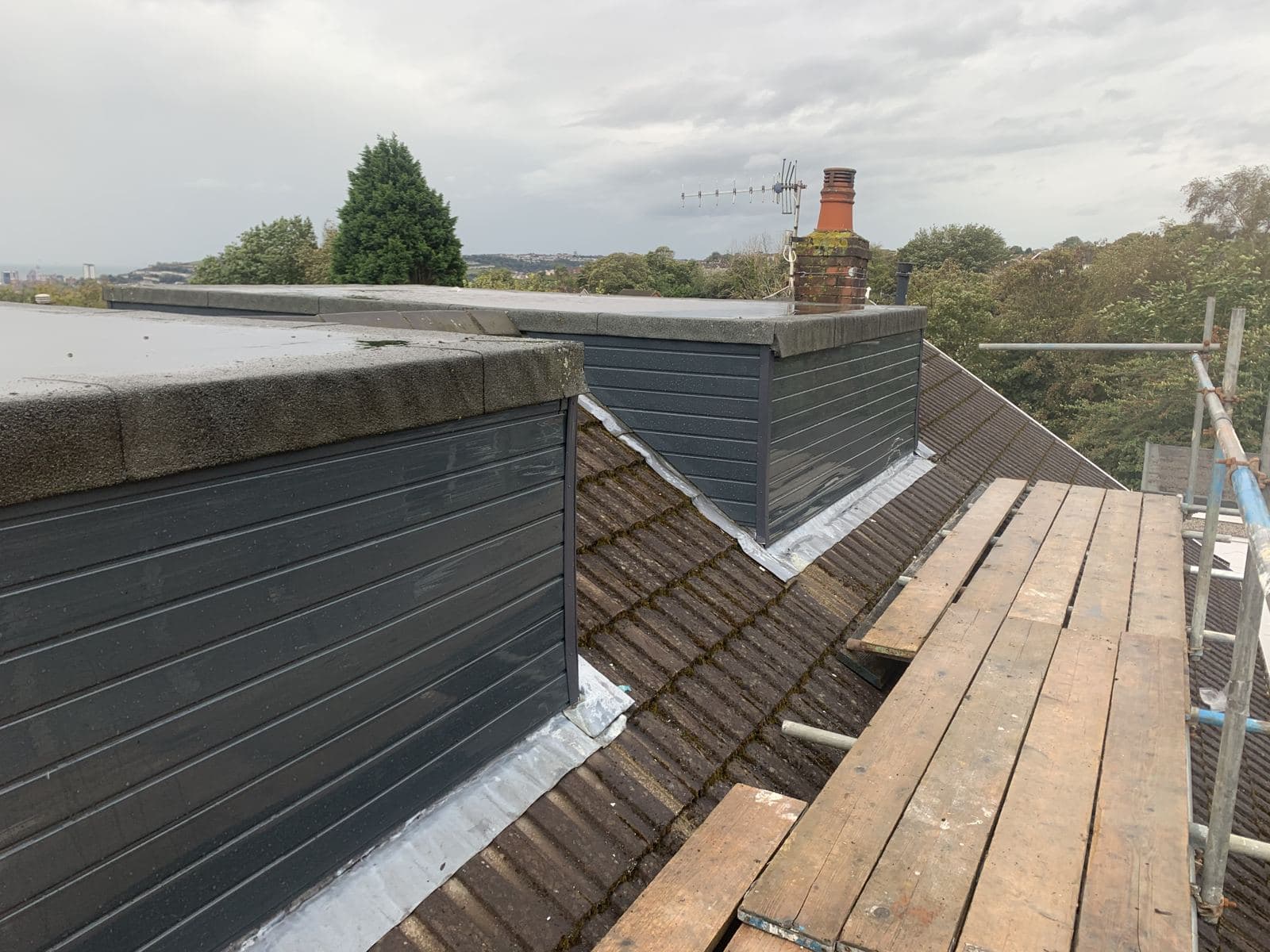 Lead flashing where a clad dormer meets the roof tiles