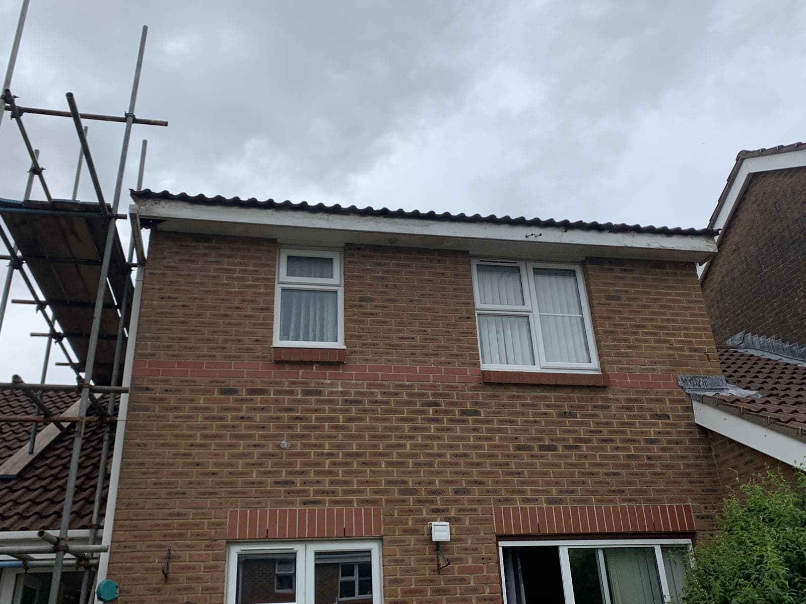 House with scaffolding up for new fascias, soffits and gutters