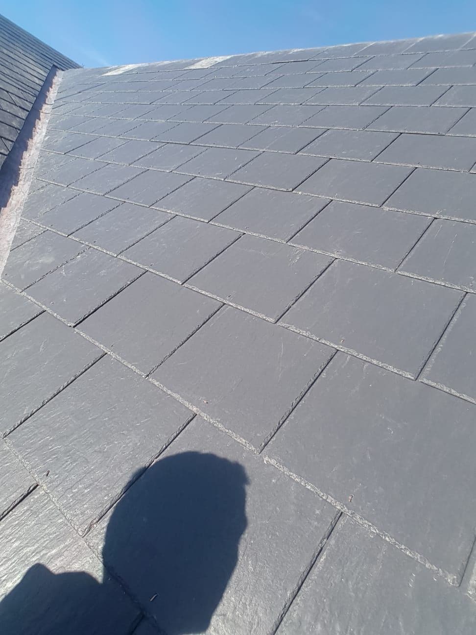 Slates back in place on a pitched roof