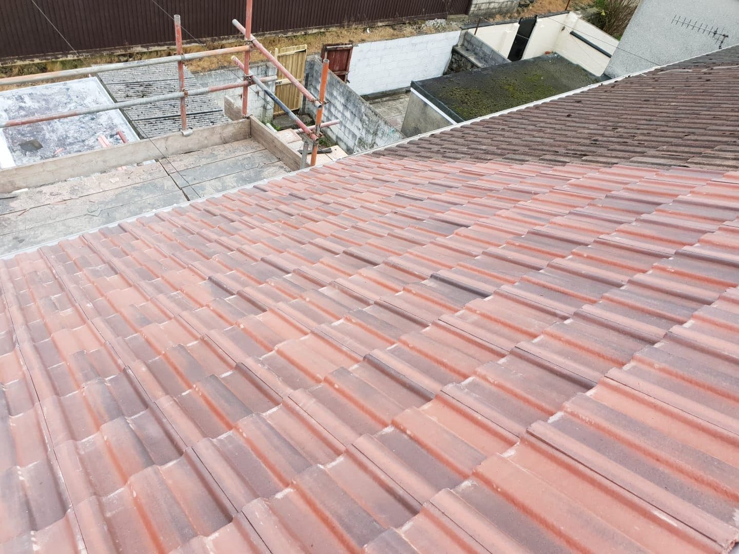Roof re-tiled in red concrete tiles